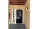 Front door of unit number 103 with a black door, a side light, and beige siding at 8728 Mallard Reserve Dr # 103, Tampa, FL 33614