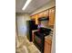 Updated kitchen featuring granite countertops, wooden cabinets, and modern black appliances at 8728 Mallard Reserve Dr # 103, Tampa, FL 33614
