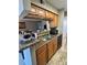 Kitchen with stainless steel sink, microwave, and wooden cabinets at 8728 Mallard Reserve Dr # 103, Tampa, FL 33614