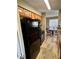 Galley kitchen featuring black appliances and oak cabinets at 8728 Mallard Reserve Dr # 103, Tampa, FL 33614