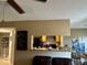 Open view into a compact kitchen featuring wooden cabinets, and a breakfast bar at 8728 Mallard Reserve Dr # 103, Tampa, FL 33614