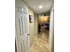View from hallway into a living room with tile flooring, fan, and contemporary furnishings at 8728 Mallard Reserve Dr # 103, Tampa, FL 33614