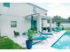 The backyard with swimming pool, lounge furniture, and covered patio offers a relaxing outdoor retreat at 12236 Fairlawn Dr, Riverview, FL 33579