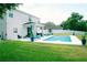 Well-maintained backyard with a pool, covered patio, lush grass, and plenty of space for entertaining at 12236 Fairlawn Dr, Riverview, FL 33579