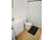 Well lit bathroom featuring a stylish vanity, modern toilet, and a shower with patterned curtain at 12236 Fairlawn Dr, Riverview, FL 33579