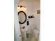 Charming powder room featuring pedestal sink, dark fixtures, and round mirror at 12236 Fairlawn Dr, Riverview, FL 33579