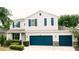 Charming two-story home featuring light gray siding, dark blue shutters, well-maintained landscaping, and a three car garage at 12236 Fairlawn Dr, Riverview, FL 33579