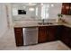 Open concept kitchen with granite counters, stainless appliances, and wood cabinets at 12236 Fairlawn Dr, Riverview, FL 33579