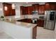 Gourmet kitchen with granite counters, stainless appliances, and wood cabinets at 12236 Fairlawn Dr, Riverview, FL 33579
