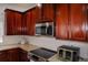 Gourmet kitchen featuring wood cabinets and stainless appliances at 12236 Fairlawn Dr, Riverview, FL 33579