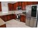 Gourmet kitchen with stainless steel appliances, wood cabinets and granite countertop at 12236 Fairlawn Dr, Riverview, FL 33579