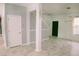 Spacious and bright living area featuring marble floors, decorative columns, leading to the front door and staircase at 12236 Fairlawn Dr, Riverview, FL 33579