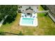 Aerial view of a backyard featuring a pristine pool and lounge area, ideal for relaxing in the sun at 12236 Fairlawn Dr, Riverview, FL 33579