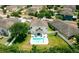 Aerial view of a home with a pristine backyard pool and ample seating, perfect for outdoor relaxation at 12236 Fairlawn Dr, Riverview, FL 33579