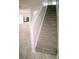 Elegant staircase design featuring carpeted steps, and an open view to the living area adorned with marble floors at 12236 Fairlawn Dr, Riverview, FL 33579