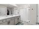 Bright bathroom featuring double vanity with marble countertop and modern grey cabinetry plus a walk-in shower at 16750 Sunburst Lake St, Wimauma, FL 33598