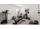 A room is set up as a home gym with a variety of fitness equipment at 16750 Sunburst Lake St, Wimauma, FL 33598