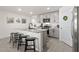 Modern kitchen featuring granite countertops, stainless steel appliances, gray cabinets and a breakfast bar at 16750 Sunburst Lake St, Wimauma, FL 33598