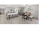 Open concept kitchen with granite countertops, stainless steel appliances, and breakfast bar seating at 16750 Sunburst Lake St, Wimauma, FL 33598