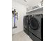A laundry room features modern LG washer and dryer set and a vacuum cleaner at 16750 Sunburst Lake St, Wimauma, FL 33598