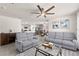 Bright living room open to kitchen and dining area, featuring comfortable seating and modern decor at 16750 Sunburst Lake St, Wimauma, FL 33598
