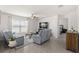 Bright living room with comfortable seating, neutral tones, and tile flooring creating a cozy atmosphere at 16750 Sunburst Lake St, Wimauma, FL 33598