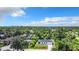 Aerial shot of the home surrounded by lush greenery and neighboring houses at 18392 Poston Ave, Port Charlotte, FL 33948