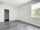 Bedroom featuring modern wood-look flooring and a bright window at 18392 Poston Ave, Port Charlotte, FL 33948