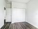 Bedroom with closet and wood-look flooring offering ample space at 18392 Poston Ave, Port Charlotte, FL 33948