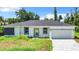 Charming single-story home with a well-manicured lawn and a two-car garage at 18392 Poston Ave, Port Charlotte, FL 33948