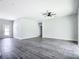 Large living room with gray vinyl floors, recessed lighting, and fan creating a modern and inviting space at 18392 Poston Ave, Port Charlotte, FL 33948