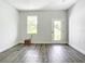 A brightly lit, unfurnished living room with modern flooring and new paint at 18392 Poston Ave, Port Charlotte, FL 33948