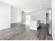 Large living area featuring wood flooring and a modern kitchen island at 18392 Poston Ave, Port Charlotte, FL 33948