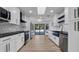 Spacious kitchen featuring stainless appliances, black countertops and white cabinets at 4907 Parson Brown Ln, Palm Harbor, FL 34684