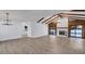 Open-concept living space with vaulted ceilings, a fireplace, and access to the outdoor pool area at 4907 Parson Brown Ln, Palm Harbor, FL 34684