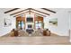 Spacious living room featuring vaulted ceilings with exposed wood beams and a cozy fireplace at 4907 Parson Brown Ln, Palm Harbor, FL 34684