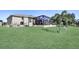 Well-maintained backyard featuring an extended screened lanai, lush green grass, and tasteful landscaping at 5497 56Th E Ct, Bradenton, FL 34203