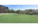 Waterfront backyard with lush lawn, mature palms, and screened lanai offers a serene outdoor retreat at 5497 56Th E Ct, Bradenton, FL 34203