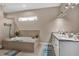 Bathroom featuring a soaking tub, walk-in shower, and dual sink vanity at 5497 56Th E Ct, Bradenton, FL 34203
