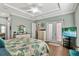 Bright bedroom featuring a tray ceiling, patio access, and ample dresser space at 5497 56Th E Ct, Bradenton, FL 34203