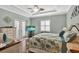 Bedroom boasting a tray ceiling, patio access, and an entertainment center at 5497 56Th E Ct, Bradenton, FL 34203