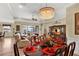 Open-concept dining area flows into the living room, featuring a stunning chandelier and comfortable seating at 5497 56Th E Ct, Bradenton, FL 34203
