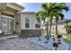 Home entrance featuring beautifully landscaped yard and decorative stone at 5497 56Th E Ct, Bradenton, FL 34203