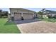 Lovely single-story home with a brick driveway and a two-car garage at 5497 56Th E Ct, Bradenton, FL 34203