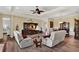 Inviting living area with hardwood floors, comfortable seating, and a view into the dining room at 5497 56Th E Ct, Bradenton, FL 34203