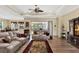 Comfortable living room with hardwood floors, neutral-toned furniture, and a view of the outdoor pool at 5497 56Th E Ct, Bradenton, FL 34203