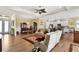 Open-concept living area with a modern kitchen and dining space with hardwood floors throughout at 5497 56Th E Ct, Bradenton, FL 34203