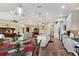 Spacious living area featuring hardwood floors, a large TV, and an open floor plan into the kitchen at 5497 56Th E Ct, Bradenton, FL 34203