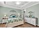 Calming main bedroom features a tray ceiling and pale green walls, creating a serene retreat at 5497 56Th E Ct, Bradenton, FL 34203