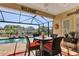Inviting screened-in patio with dining set, pool, and scenic water views at 5497 56Th E Ct, Bradenton, FL 34203